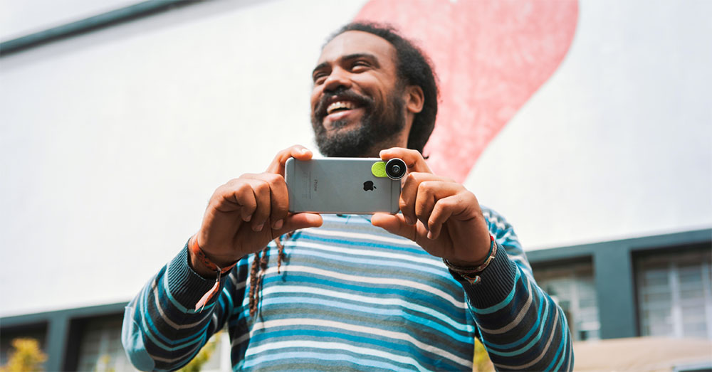 Man holding an iphone with a Limelens lens on it